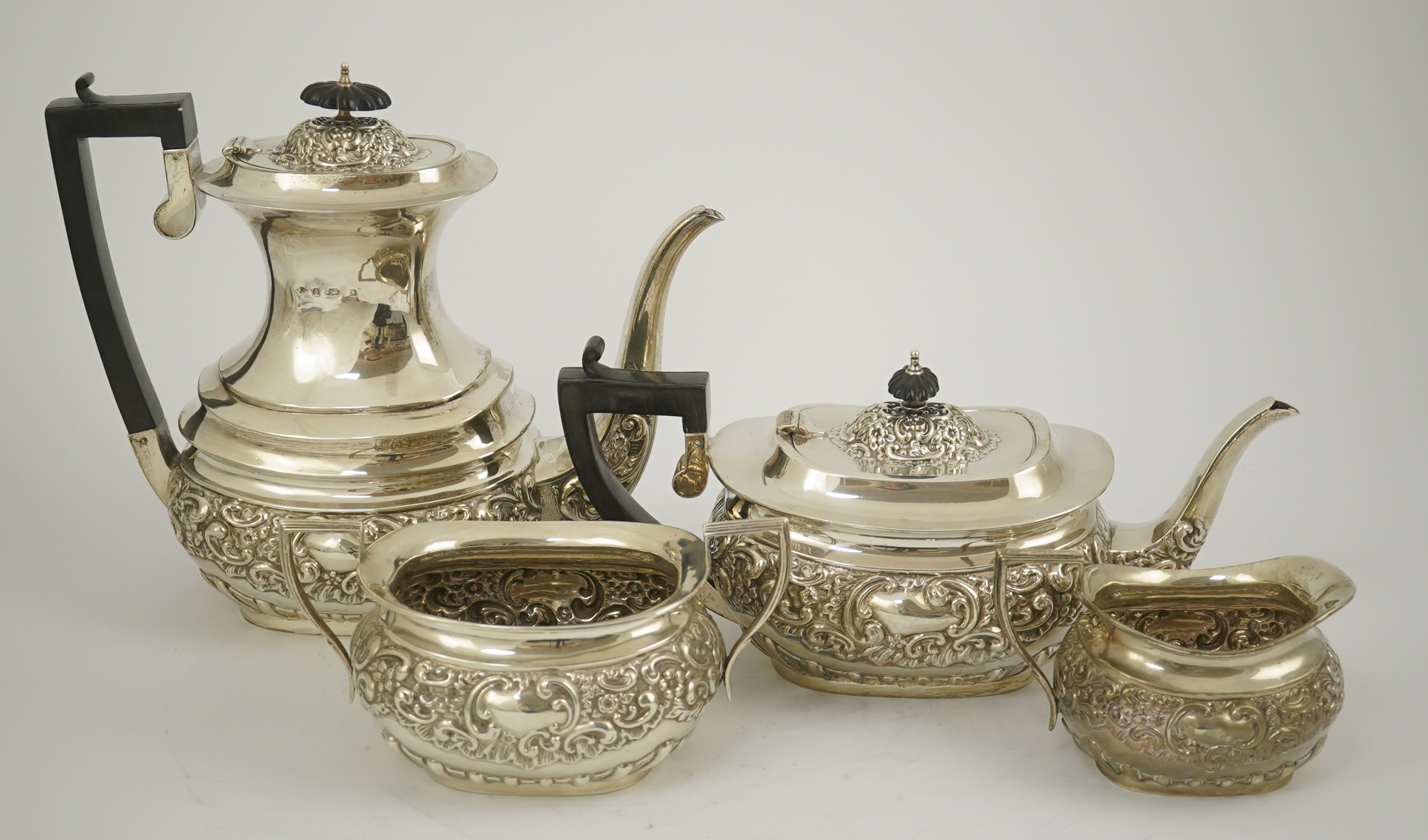 An Edwardian embossed silver four piece tea and coffee set, by S. Glass